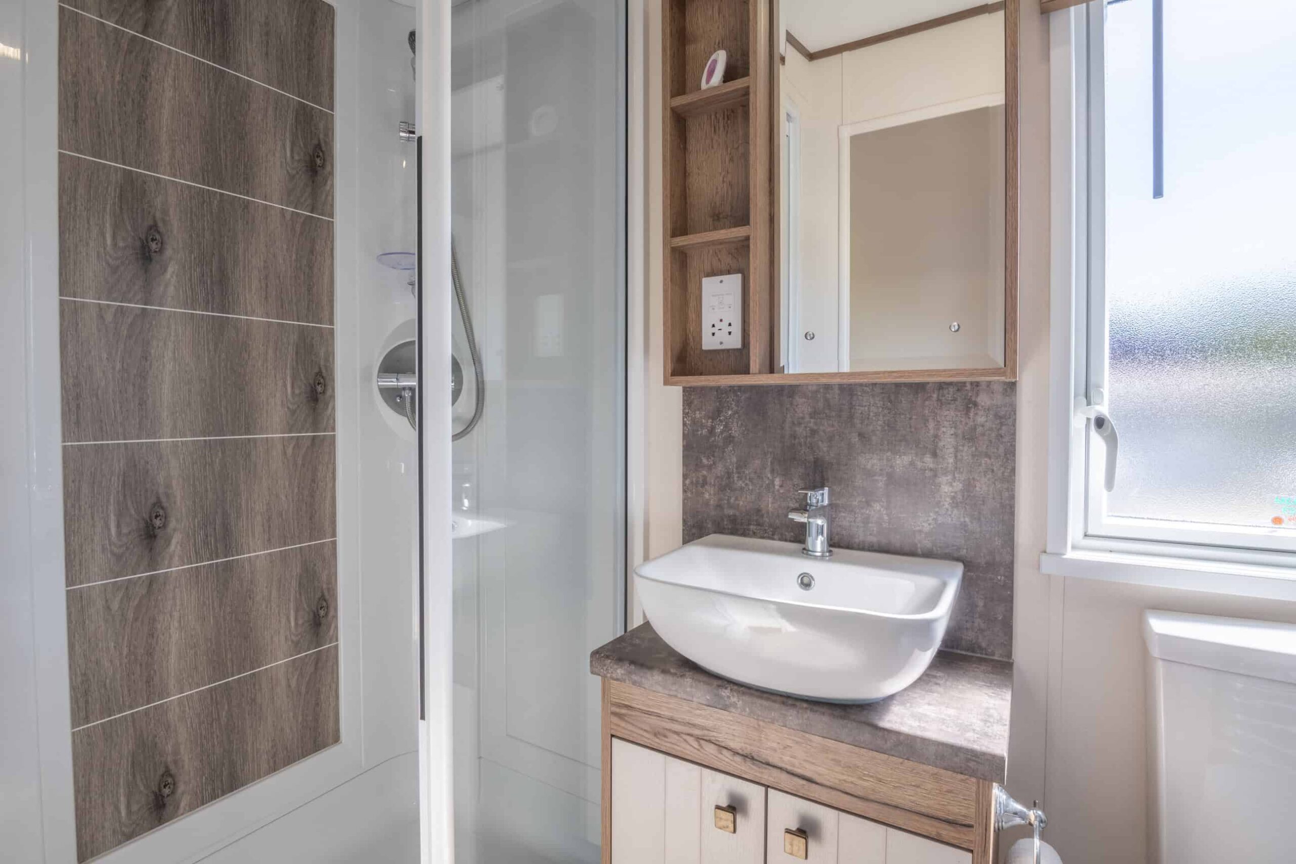 Lodge bathroom interior with sink and shower.