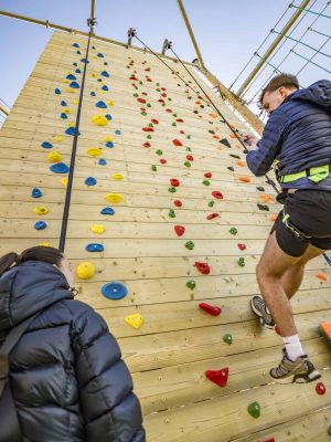 Climber returning to the foot of vertical climbing wall.