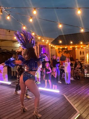 Entertainers dance onstage at event.