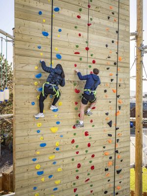 The vertical climbing wall at Whitehouse Leisure Park with two climbers ascending.