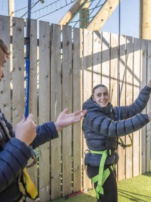 Two climbers talking at the foot of the Whitehouse Leisure Park vertical climbing wall.