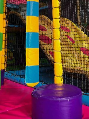 View of soft play area showing slide and netting.